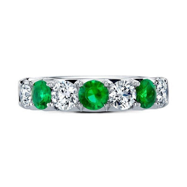 Custom made band featuring .78 carats total weight in round emeralds and 1.33 carats total weight in round brilliant cut diamonds set in platinum.