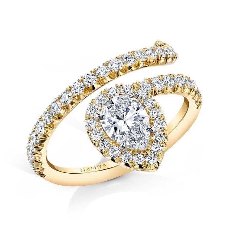 Hand fabricated single Embrace ring featuring a .70 carat pear shaped center diamond with .67 carats total weight in accent diamonds set in 18k yellow gold.