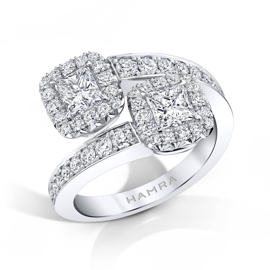 Custom made embrace ring featuring 1.00 carats total weight in princess cut center diamonds with .85 carats total in round brilliant cut accent diamonds set in 18k white gold.