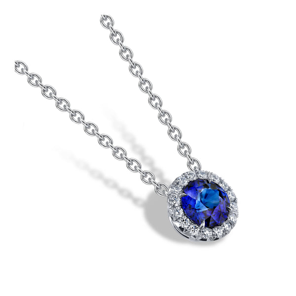 Hand crafted necklace featuring a 1.30 carat round sapphire with .25 carats total weight in round brilliant cut diamond accents set in platinum with an 18