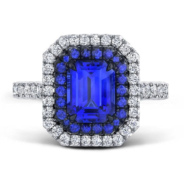 Custom made ring featuring a 2.21 carat emerald cut blue sapphire with .75 carats total weight in round brilliant cut diamonds and .31 carats total in sapphire accents set in platinum.