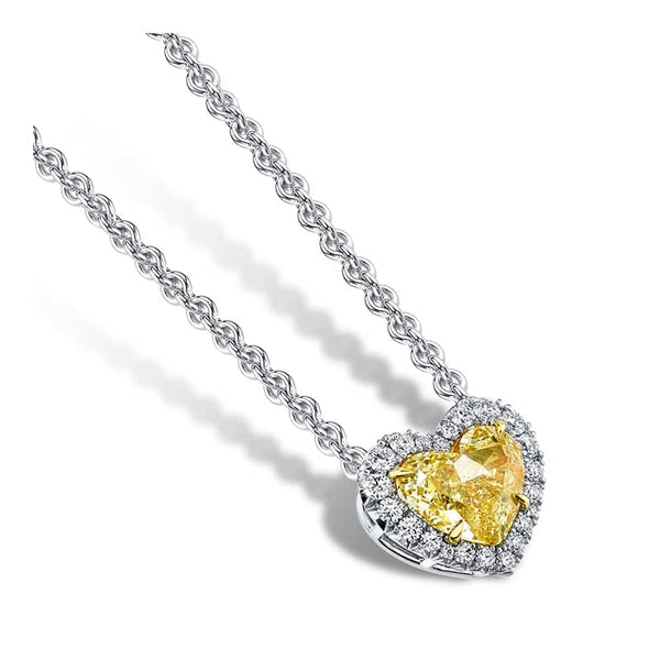 Custom made necklace featuring a 1.56 carat heart shaped fancy yellow diamond center stone with a white diamond halo consisting of .22 carats total weight in round brilliant cut diamonds set in platinum.e