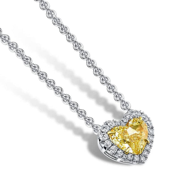 Custom made necklace featuring a 2.01 carat heart shaped fancy yellow diamond center stone with a white diamond halo consisting of .25 carats total weight in round brilliant cut diamonds set in platinum.