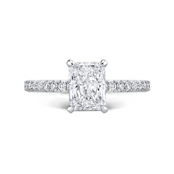 Custom made ring that features a 1.55 carat radiant cut center diamond with .43 carats total weight in round brilliant cut accent diamonds se in platinum.