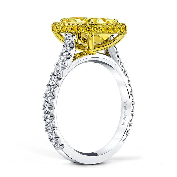 Custom made ring featuring a 3.02 carat fancy yellow radiant diamond with .69 carats total weight in round brilliant cut white diamonds and .56 carats total in round fancy yellow accent diamonds set in platinum and 18k yellow gold.