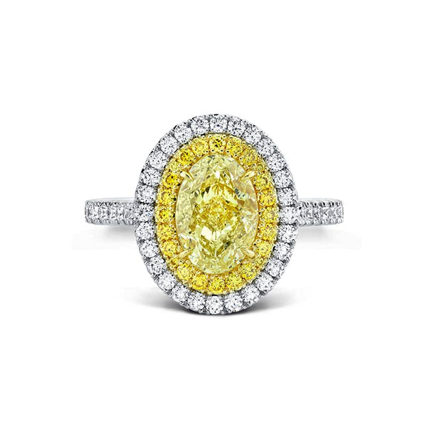 Custom handcrafted ring featuring a 1.01 carat fancy yellow oval shaped diamond center with .55 carats total weight in round brilliant cut white diamonds and .13 carats total in fancy yellow round brilliant cut accent diamonds set in platinum and 18k yellow gold.