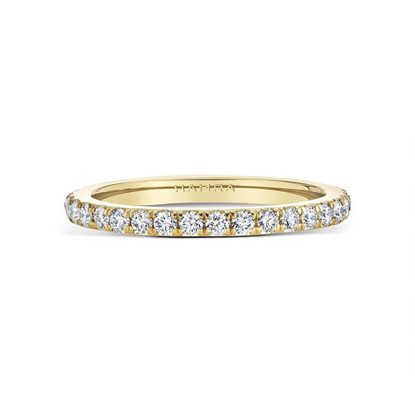 Eternity band featuring .65 carats total weight in round brilliant cut diamonds set in 18k yellow gold.