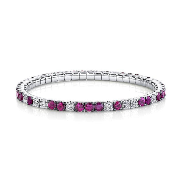 Custom made eternity bracelet featuring 7.02 carats total weight in rubies and 3.45 carats total in round brilliant cut diamonds set in 18k white gold.