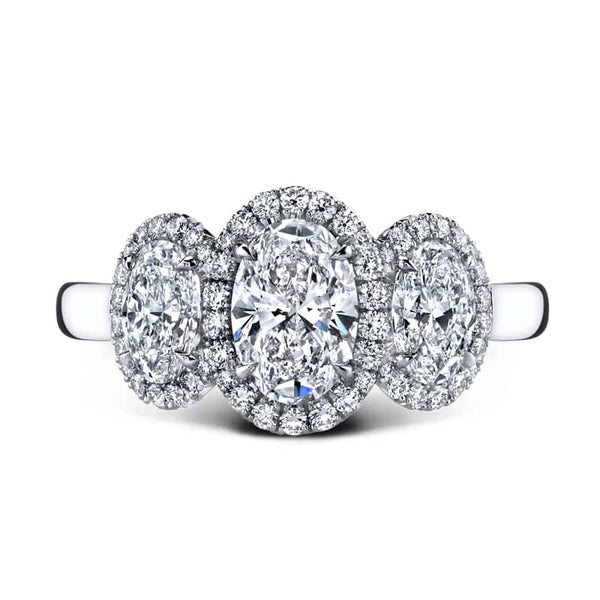 Custom made ring featuring a 1.01 carat oval shaped center stone, 1.02 carats total weight in oval shaped side stones and 029 carats total in round brilliant cut accent stones set in platinum.