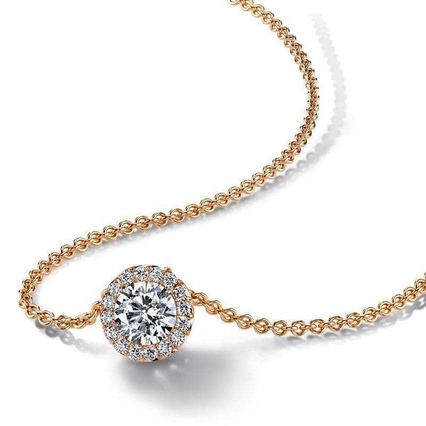 Hand crafted necklace featuring a 1 50 ct round brilliant cut diamond center surrounded by an additional .30 carats total weight in accent diamonds set in 18k rose gold.