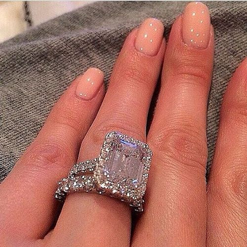 womans hand with engagement ring on