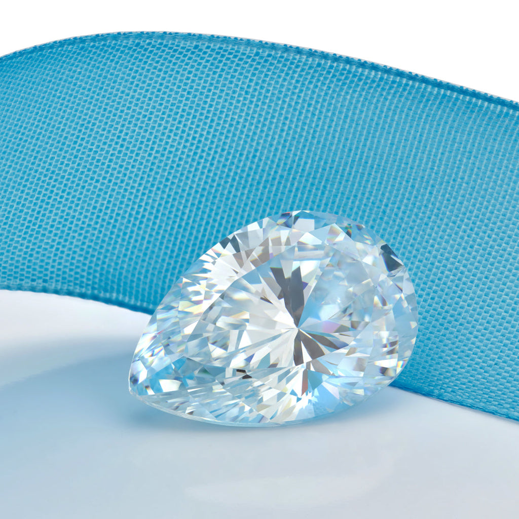 Loose pear shaped diamond with a blue ribbon