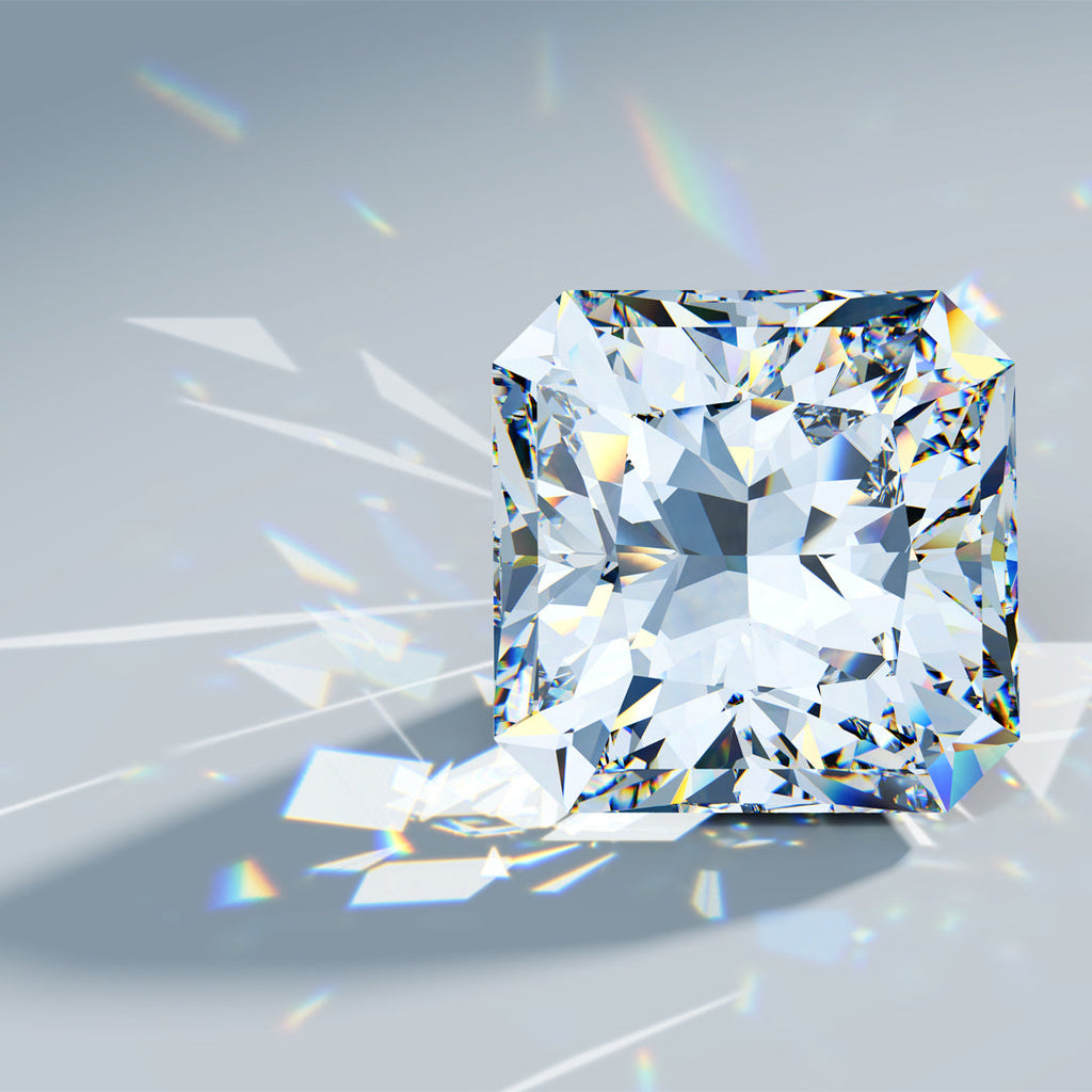 Picture of a loose radiant cut diamond on a grey background..