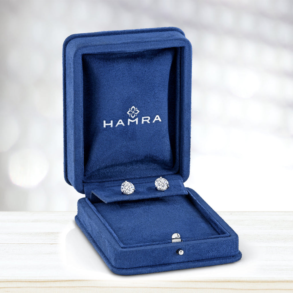 Jewelry box with diamond stud earrings inside.