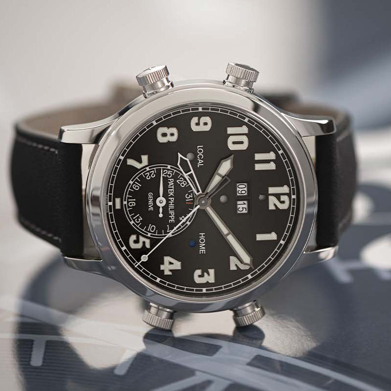 Mens luxury watch with black dial and white gold case.