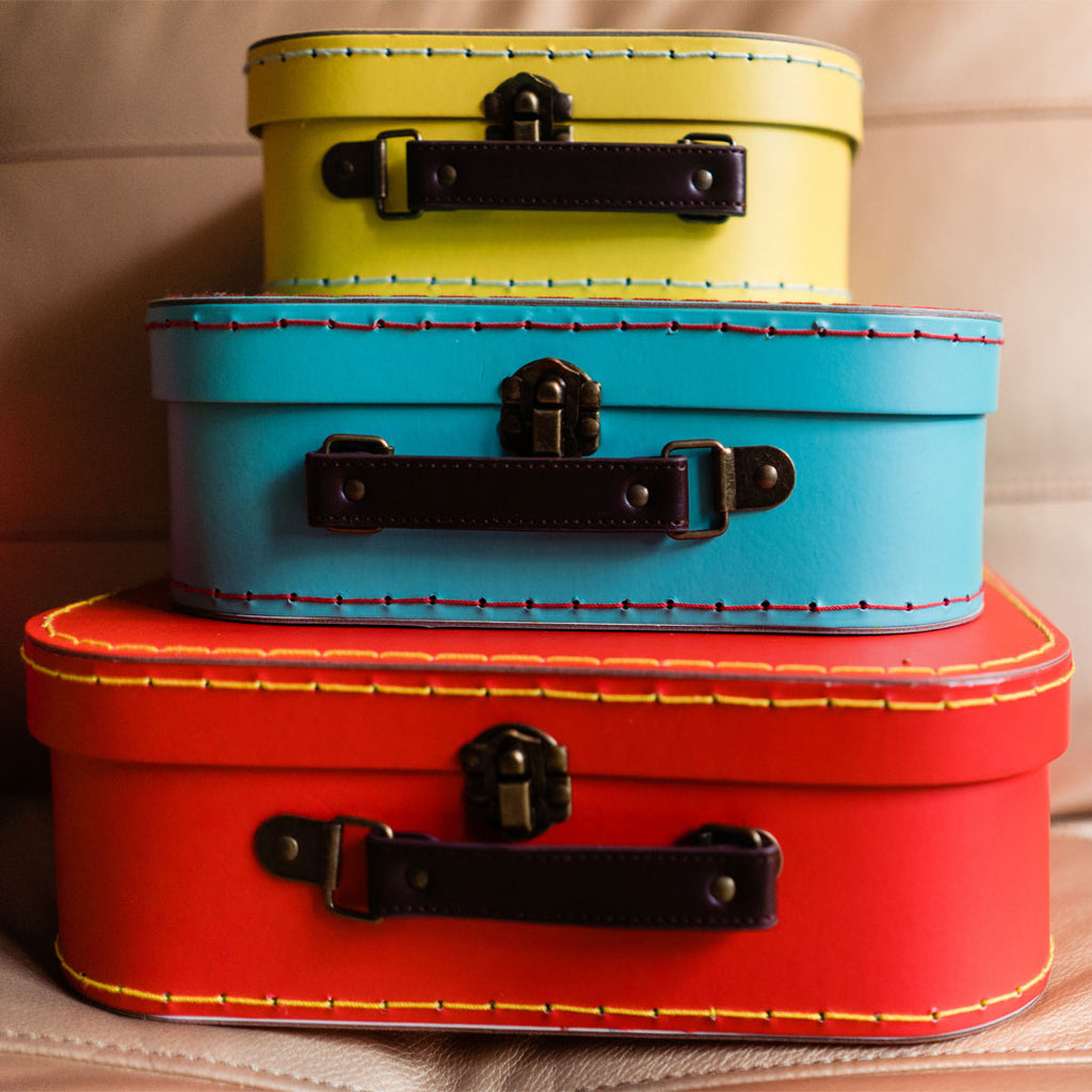 red, blue and yellow suitcases