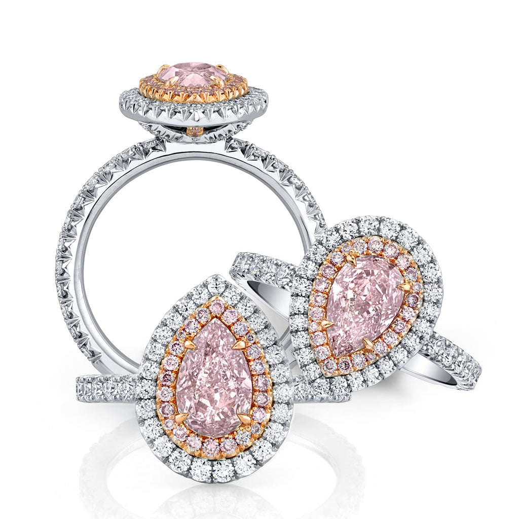 Image of three pink diamond and white diamond rings.