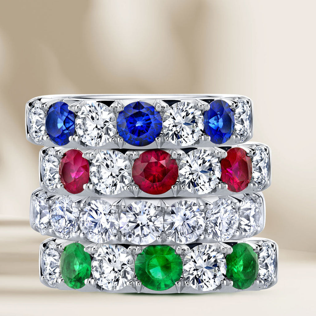 4 eternity wedding bands with diamonds, sapphires, rubies and emeralds.