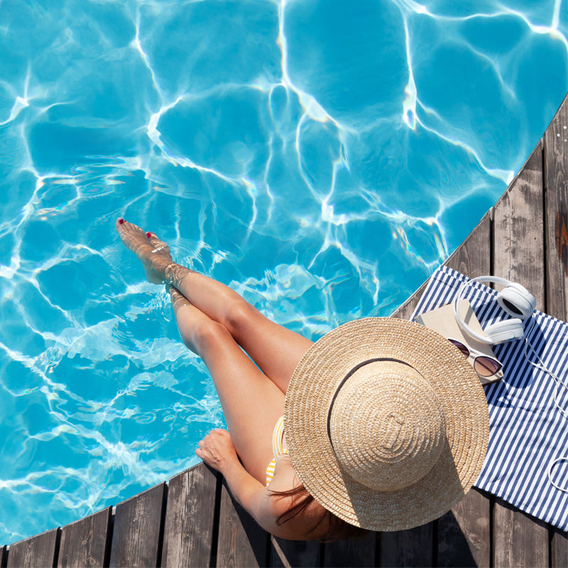 Woman sitting poolside