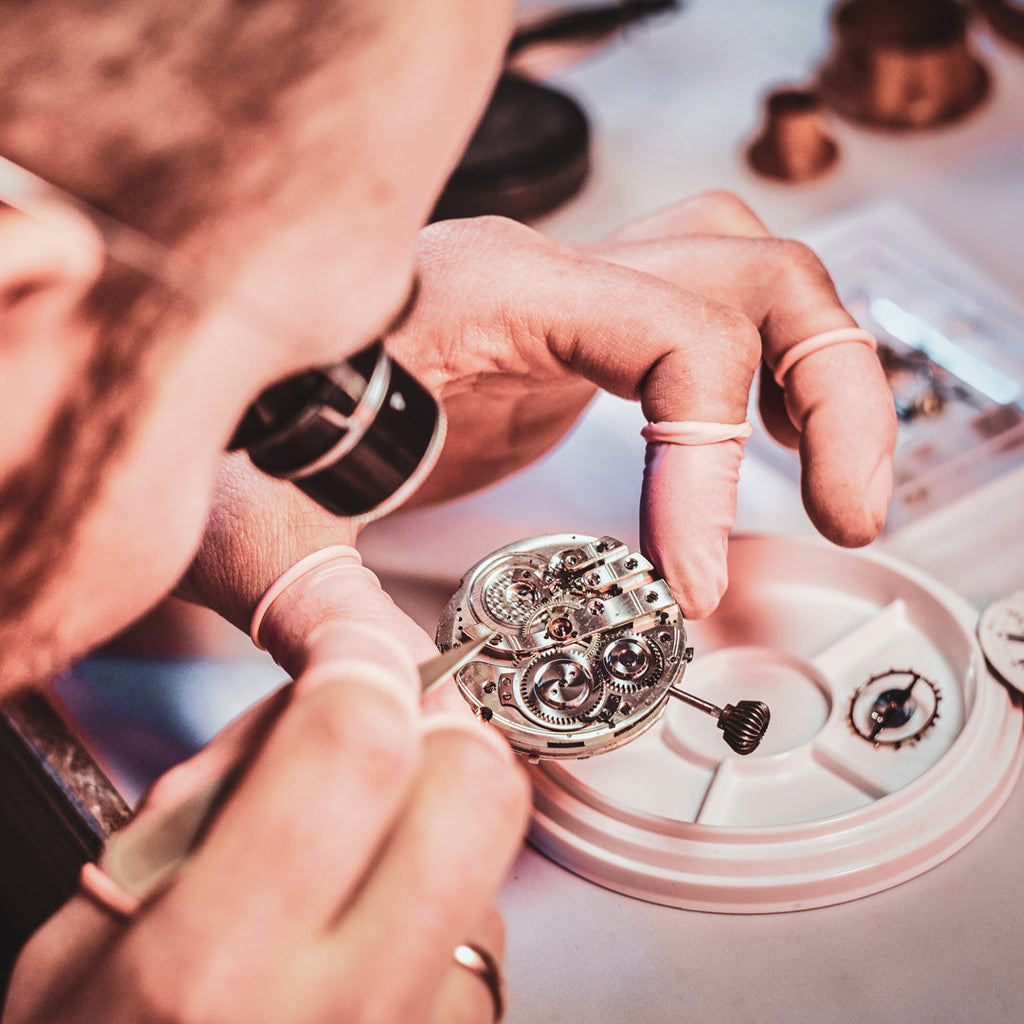 Watchmaker working on a watch movement.
