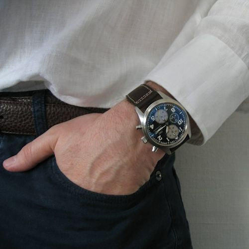 man wearing watch with hand in pocket