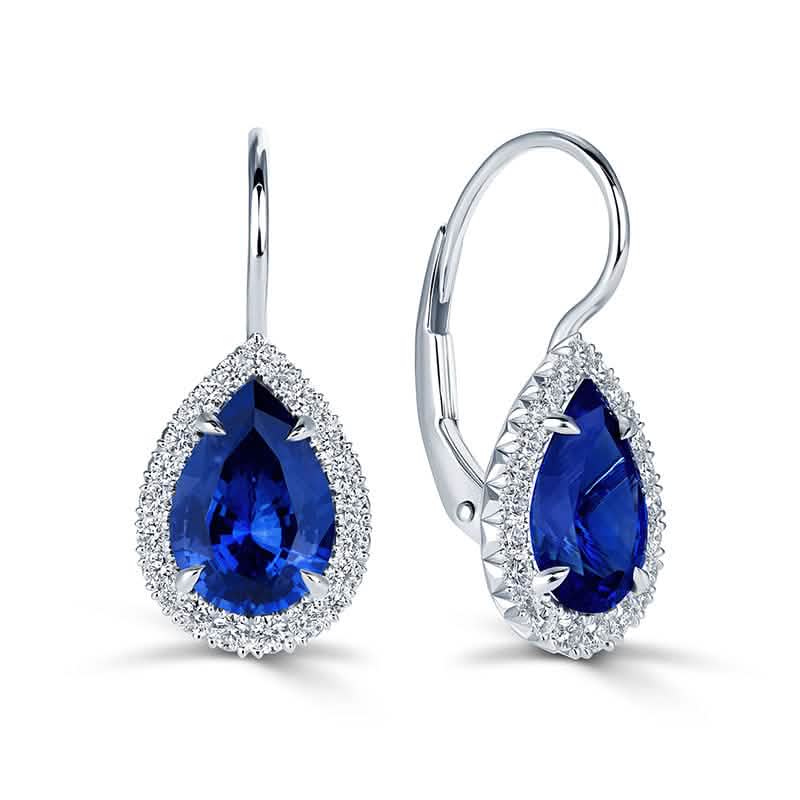 Rolex Sapphire & Diamond Drop Earrings in <p>These platinum drop earrings feature 3.20 carats of pear-shaped blue sapphires surrounded by 0.37 carats of round brilliant diamonds. The vivid blue center stones are beautifully defined by delicate diamond halos, creating a timeless balance of color and sparkle.</p>