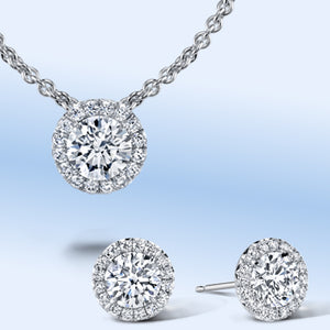 Diamond necklace and earring set with diamond halos in platinum