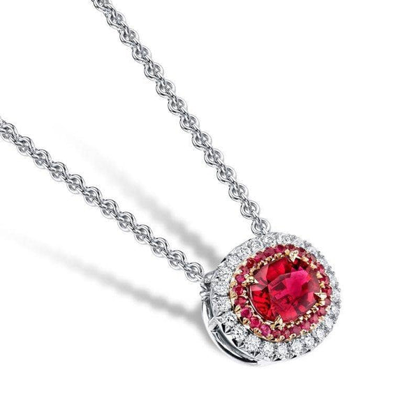 Hand crafted necklace featuring a 1.21 carat oval shaped ruby center stone with .25 carats total weight in diamonds and .16 carats total in accent rubies set in platinum and 18k rose gold.