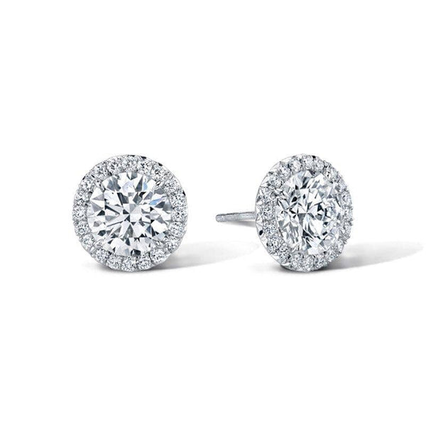 Hand crafted stud earrings featuring 2.00 carats total weight in round brilliant cut center diamonds with .36 carats total in accent diamonds set in 18k white gold.