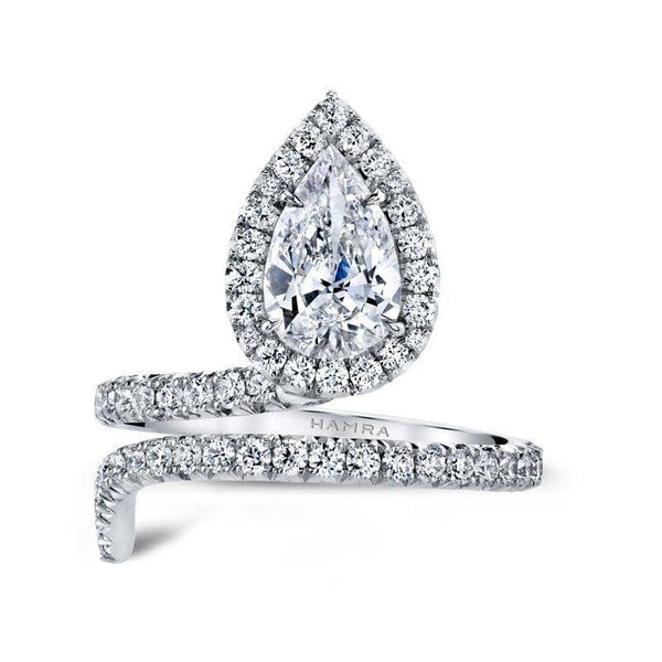 Hand fabricated single Embrace ring featuring a 1.12 carat pear shaped center diamond with .66 carats total weight in accent diamonds set in platinum.