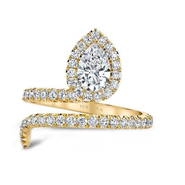 Hand fabricated single Embrace ring featuring a .70 carat pear shaped center diamond with .67 carats total weight in accent diamonds set in 18k yellow gold.
