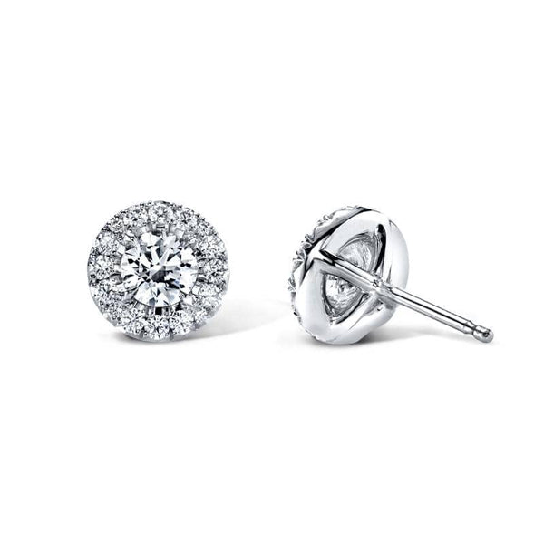 Hand crafted earrings featuring .50 carats total weight in round brilliant cut center diamonds with .17 carats total in round brilliant accent diamonds set in 18k white gold.