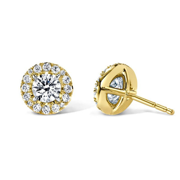 Custom made earrings featuring .74 carats total weight in round brilliant cut center diamonds with .23 carats total in round brilliant accent diamonds set in 18k yellow gold.