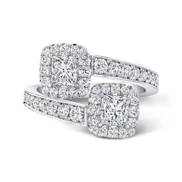 Custom made embrace ring featuring 1.00 carats total weight in princess cut center diamonds with .85 carats total in round brilliant cut accent diamonds set in 18k white gold.