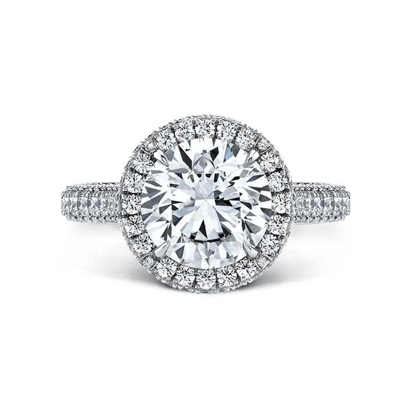 Custom made ring featuring a 3.00 carat center round brilliant cut diamond with 1.70 carats total weight in round brilliant cut accent diamonds set in platinum.