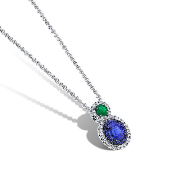 Hand crafted custom necklace featuring a 2.13 carat oval cut sapphire, a .39 carat round emerald, .45 carats total weight in round brilliant cut diamond accents and .22 carats total in round sapphires set in platinum with an adjustable 16-18