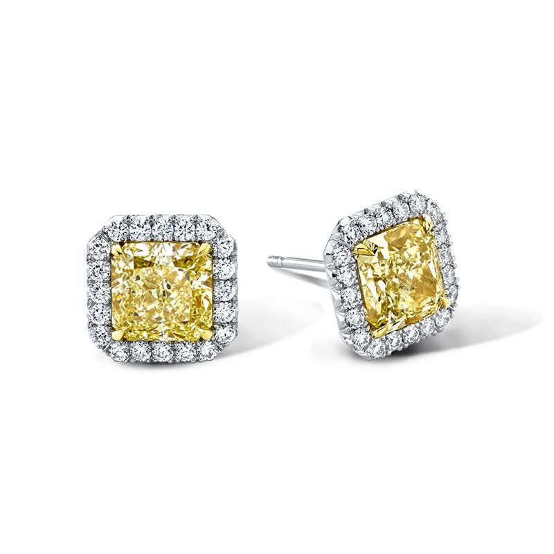 Custom made earrings featuring 2.87 carats total weight in radiant cut fancy yellow diamonds with .35 carats total weight in round brilliant cut diamond accents set in platinum and 18k yellow gold.