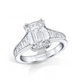 Custom made ring featuring a 4.02 carat emerald cut center diamond with 1.25 carats total weight in accent baguette diamonds and .11 carats total weight in round brilliant cut accent diamonds set in platinum.