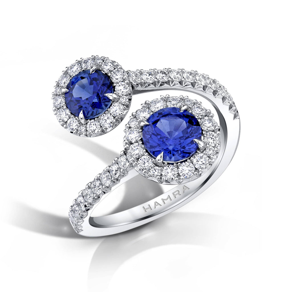 Custom made Embrace ring featuring 1.97 carats total weight in round blue sapphires with .71 carats total weight in round brilliant cut accent diamonds set in platinum.