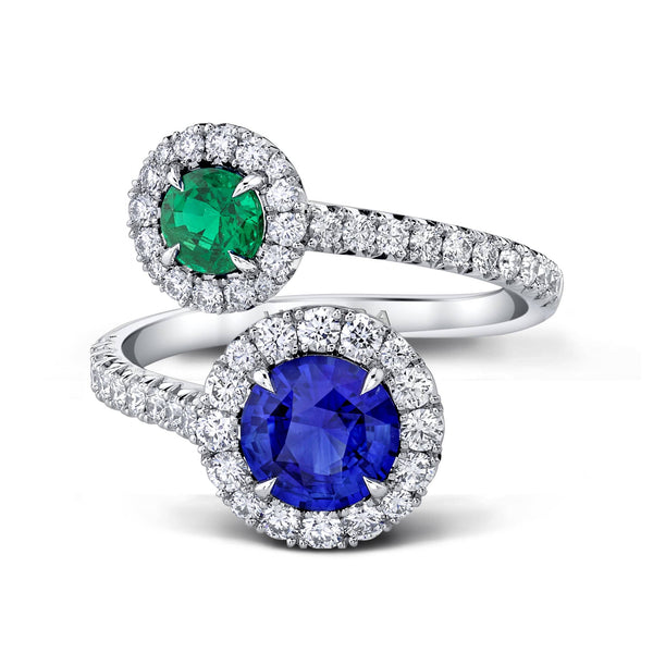 Custom made ring featuring a 1.27 carat round blue sapphire, a .46 carat round emerald and .82 carats total weight in round brilliant cut accent diamonds set in platinum.