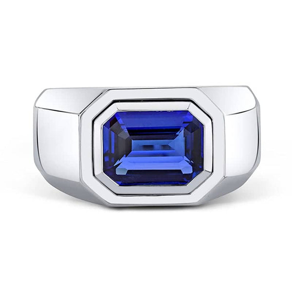 Men's ring featuring a bezel set 5.12 carat emerald cut blue sapphire set in platinum.