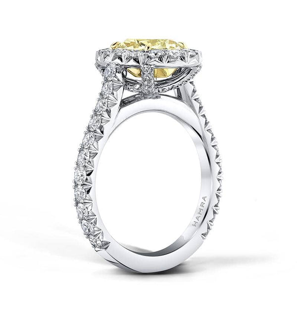 Custom made ring featuring a 2.39 carat oval shaped fancy yellow diamond with 1.14 carats total weight in round brilliant cut diamond accents set in platinum and 18k yellow gold.
