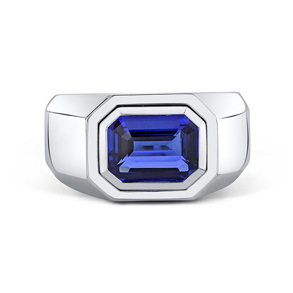 Men's ring featuring a bezel set 3.50 carat emerald cut blue sapphire set in platinum.