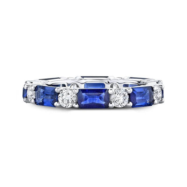 Custom made band featuring 2.81 carats total weight in emerald cut blue sapphires with .79 carats total in round brilliant cut diamonds set in 18k white gold.