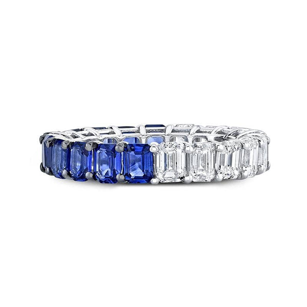 Handcrafted ring featuring 2.87 carats total weight in emerald cut blue sapphires and 2.44 carats total in emerald cut diamonds set in 18k white gold.