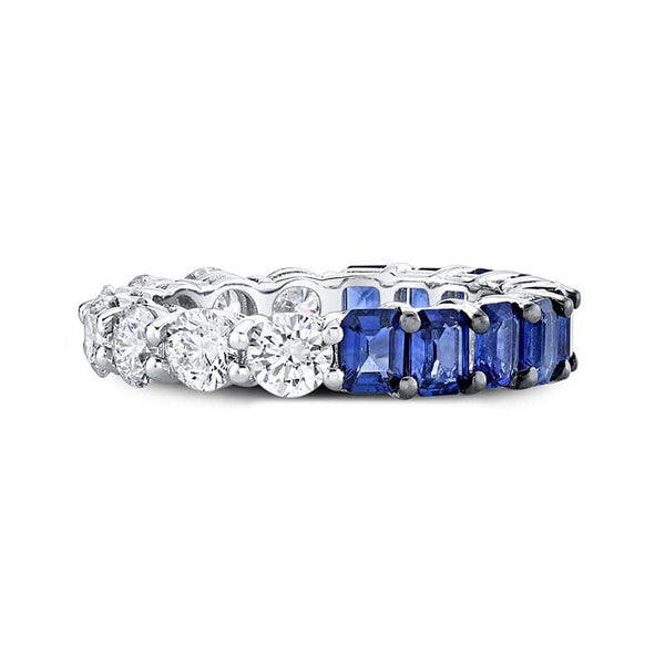 Custom made ring featuring 2.52 carats total weight in emerald cut blue sapphires and 1.93 carats total in round brilliant cut diamonds set in 18k white gold.