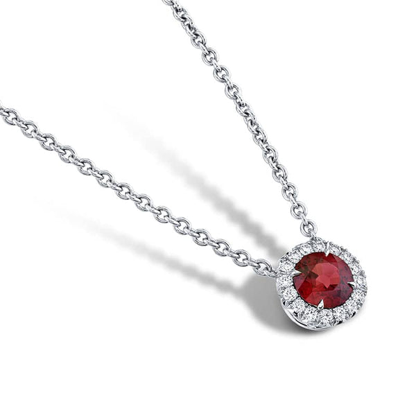 Custom made necklace featuring a 1.16 carat round ruby and .20 carats total weight in round brilliant cut diamonds set in platinum.  Includes a platinum 16-18
