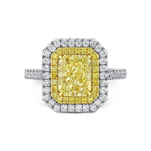 Custom handcrafted ring featuring a 2.34 carat fancy yellow radiant diamond center with .68 carats total weight in round brilliant cut diamonds set in platinum and 18k yellow gold.