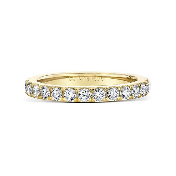 Custom made eternity band featuring 1.10 carats total weight in round brilliant cut diamonds set in 18k yellow gold.