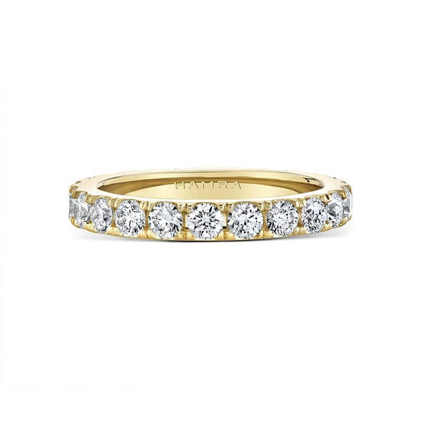 Custom made eternity band featuring 1.65 carats total weight in round brilliant cut diamonds set in 18k yellow gold.